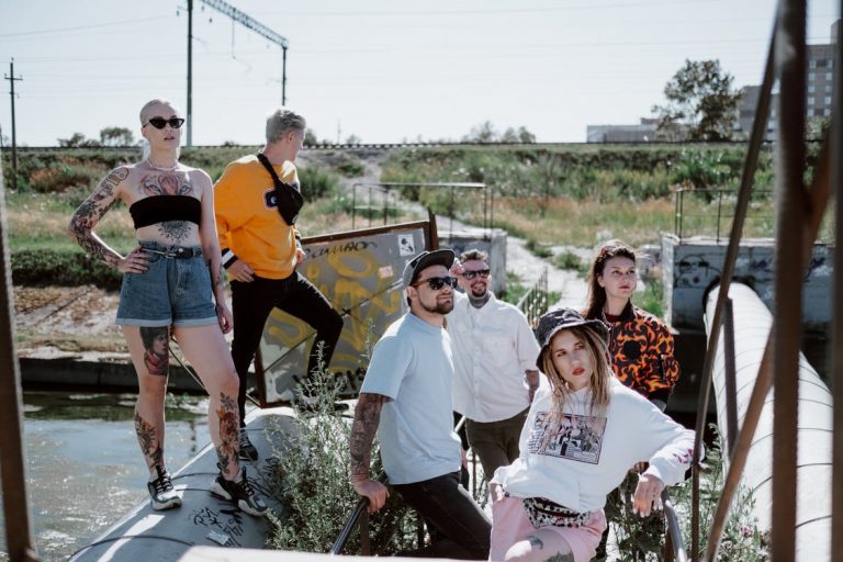 Five Streetwear Essentials Every Guy Needs Group of People in Streetwear Outfits Posing Outside