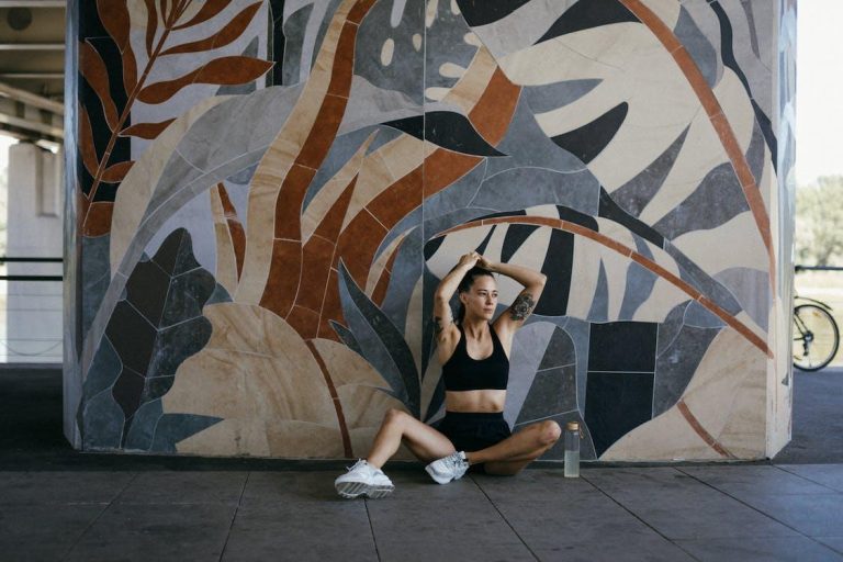 5 Best Ways to Stay in Good Physical Health Free A Tattooed Woman in Black Sports Bra Sitting on the Floor while Tying Her Hair Stock Photo